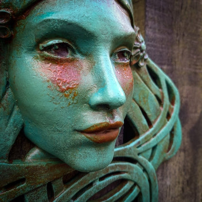 Art Nouveau inspired sculpture of beautiful female face with long stylised hair