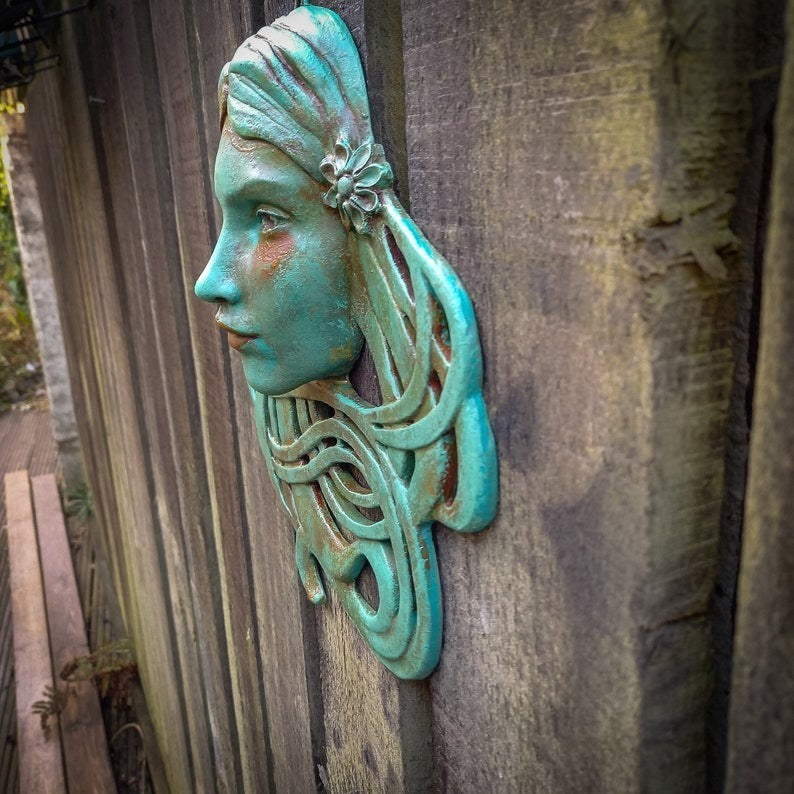 Art Nouveau inspired sculpture of beautiful female face with long stylised hair