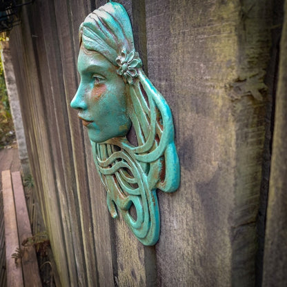 Art Nouveau inspired sculpture of beautiful female face with long stylised hair